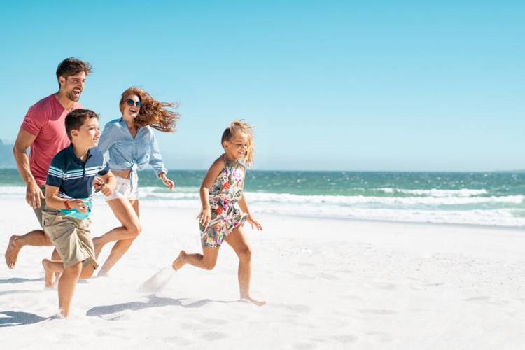 family running on the beach