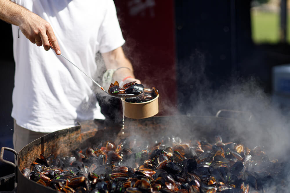 A person serving food at the seafood festival in Morehead City.