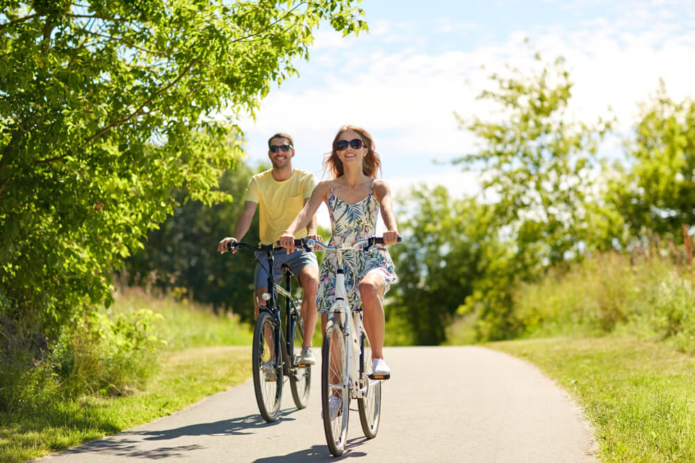 A couple riding bikes, one of the best things to do on romantic getaways to Emerald Isle, North Carolina.